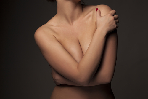 Woman covering her chest with arms